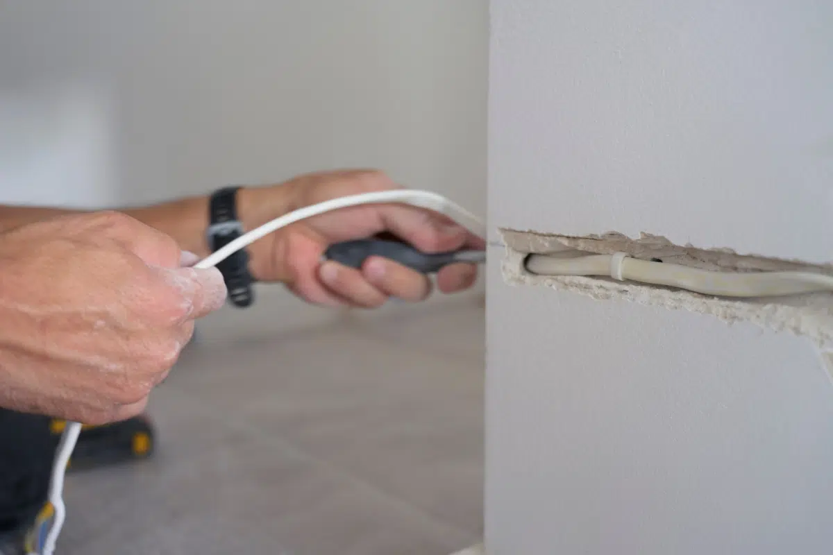 Passage d’un câble électrique encastré dans un mur